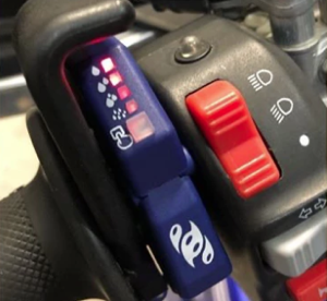 Liquid Aider button on motorcycle handlebar